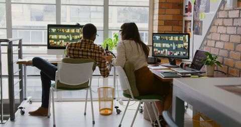 Team Collaboration with Computer Screens in Modern Office
