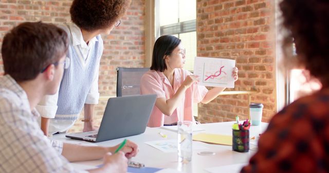 Diverse team analyzing business growth charts during meeting - Download Free Stock Images Pikwizard.com