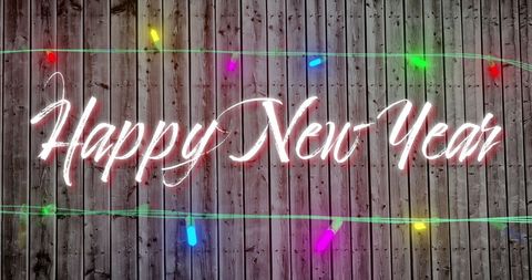 Festive New Year Greeting with Colorful Lights on Wooden Background