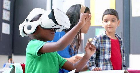 Child Experiencing VR in Classroom with Teacher and Peer Engagement - Download Free Stock Images Pikwizard.com