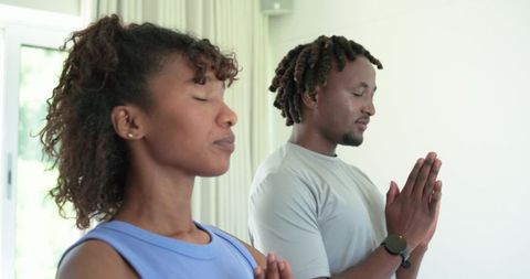African american couple practicing mindful meditation at home for wellness balance and calm