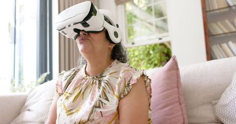 Middle-aged woman experiencing virtual reality technology
