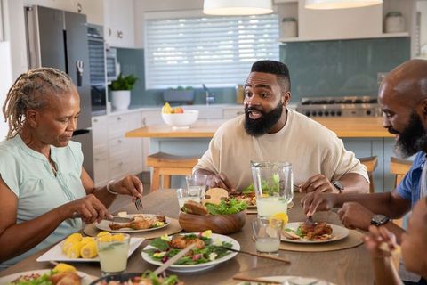 African American Family Enjoying Meal Together in Cozy Kitchen Setting