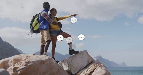 Couple Pointing Towards Ocean Horizon on Coastal Rock