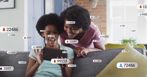 Mother and Daughter Engaging with Social Media Notifications on Tablet