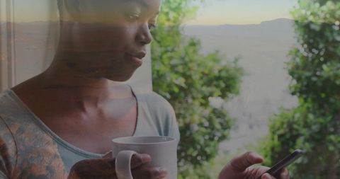 African American Woman Relaxing with Mug at Home in Natural Light