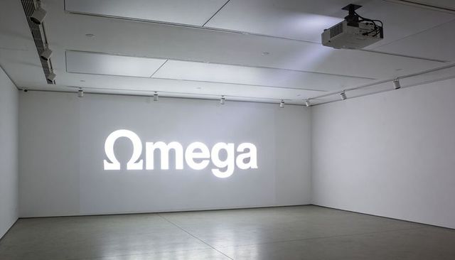 Projecting omega logo on gallery wall from ceiling-mounted projector in minimalist showroom