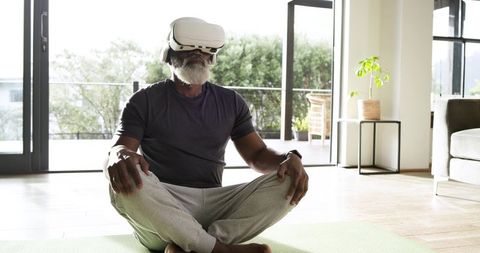 Elderly Man Utilizes VR Technology in Home Meditation