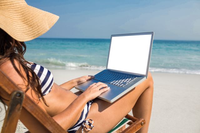 Woman with Laptop Relaxing on Beach with Transparent Hat and Clear Sky - Download Free Stock Videos Pikwizard.com