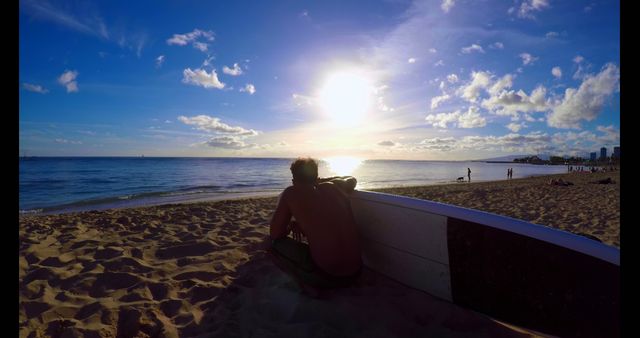 Surfer Relaxing on Sandy Beach at Sunset - Download Free Stock Images Pikwizard.com