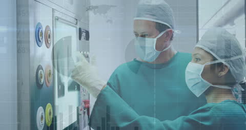 Surgeons Analyzing Digital X-ray with High-tech Interface