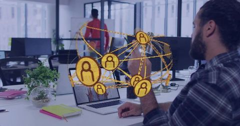 Bearded man pointing at laptop with golden network globe representing remote collaboration