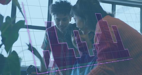 Diverse team analyzing financial data at office with digital interface