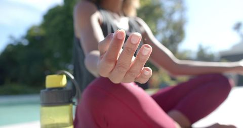 Peaceful Yoga Meditation Outdoors in Sunlit Garden Scene
