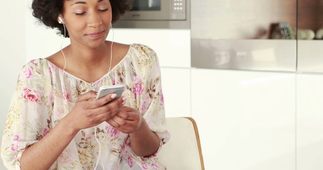 Young Woman Listening to Music on Her Phone in Bright Kitchen - Download Free Stock Images Pikwizard.com