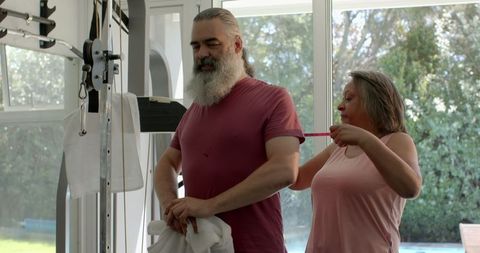 Senior Couple Laughing Together in a Cheerful Indoor Exercise Setting