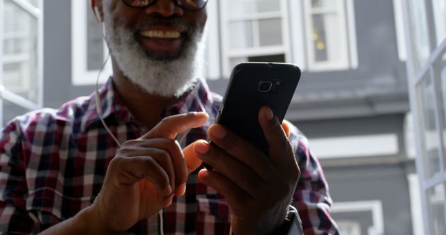 Senior Man Smiling While Using Smartphone in Urban Setting - Download Free Stock Images Pikwizard.com