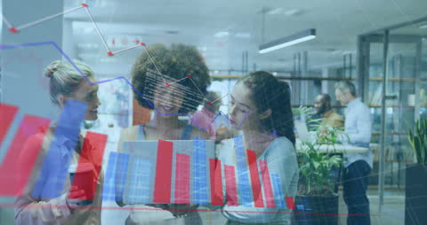 Diverse Female Coworkers Analyzing Graphs in Office Environment