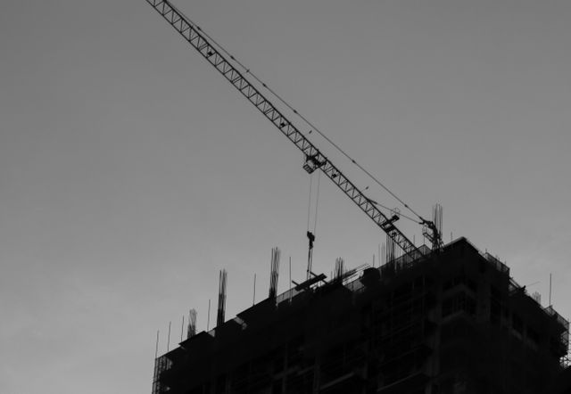 Construction Crane Lifting Materials at Construction Site - Download Free Stock Photos Pikwizard.com