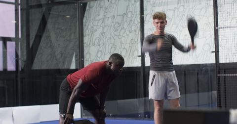 Diverse Friends Engaging Padel Tennis Action on Court