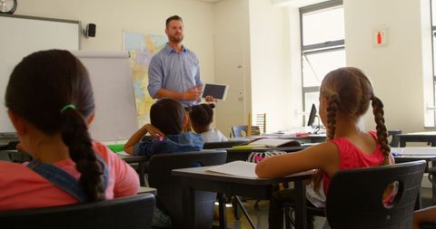 Caucasian Teacher Engaging Students with Digital Tablet in Classroom - Download Free Stock Images Pikwizard.com