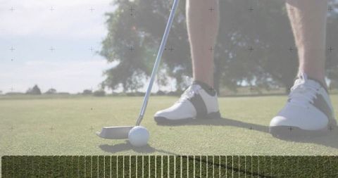 Golf putter aligning behind ball on smooth putting green with golfer in white shoes