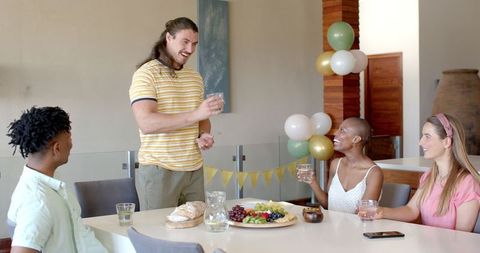 Friends Toasting at Celebration with Food and Drinks