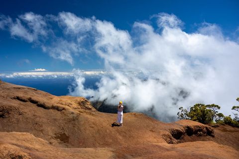 Woman Enjoying Cloudy Vista on Mountain Trail