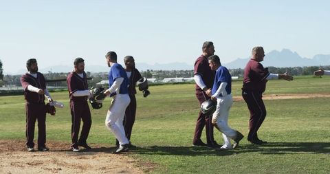 Baseball Players Displaying Sportsmanship by Shaking Hands on Field
