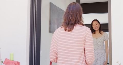 Smiling Friends Embracing at Housewarming Gathering