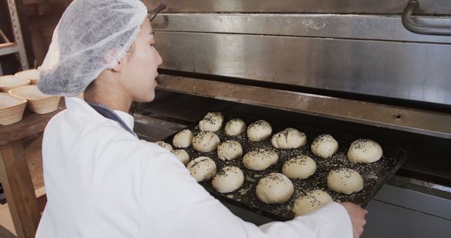 Female Baker Preparing Bread in Industrial Oven - Download Free Stock Images Pikwizard.com