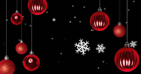 Festive Red Ornaments Hanging on Black Backdrop with Snowflakes