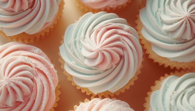 Pastel swirl cupcakes with sugar crystals on bakery tabletop