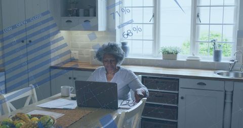 Senior Woman Analyzing Financial Data at Home