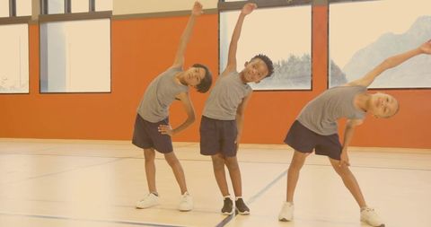 Boys Exercise with Side Bends in School Gym for Fitness and Teamwork