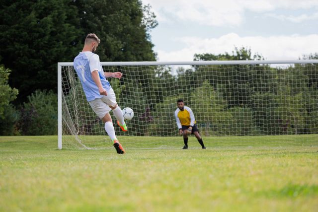 Soccer player kicking ball towards goal post - Download Free Stock Photos Pikwizard.com