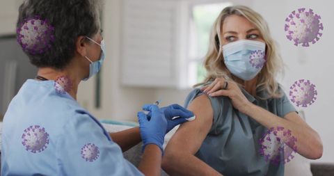 Healthcare worker giving covid-19 vaccine amid virus visualization