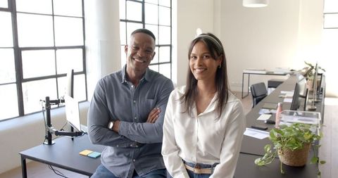 Smiling colleagues relaxing in modern office workspace