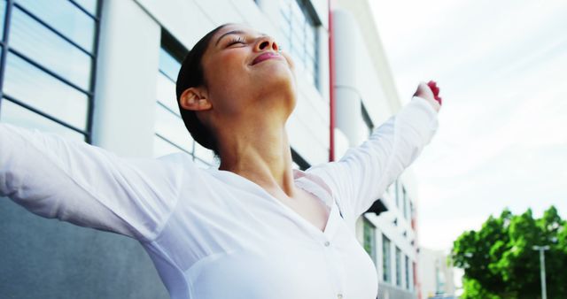 Joyful woman spreading arms embracing freedom outdoors - Download Free Stock Images Pikwizard.com