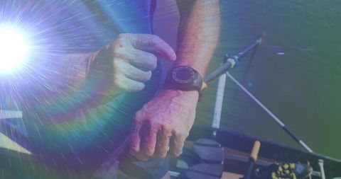 Senior Fisherman Uses Smartwatch While Fishing on Lake