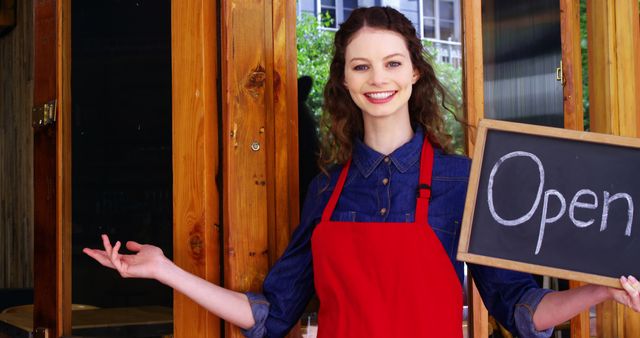 Cheerful Female Cafe Owner Holding Open Sign - Download Free Stock Images Pikwizard.com