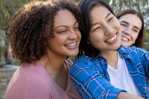 Diverse Female Friends Smiling and Taking Selfie Outdoors