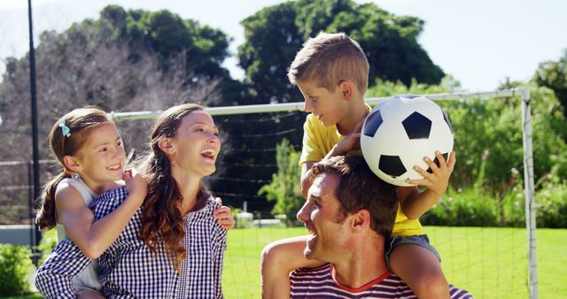 Happy Family Playing with Soccer Ball in Park - Download Free Stock Images Pikwizard.com