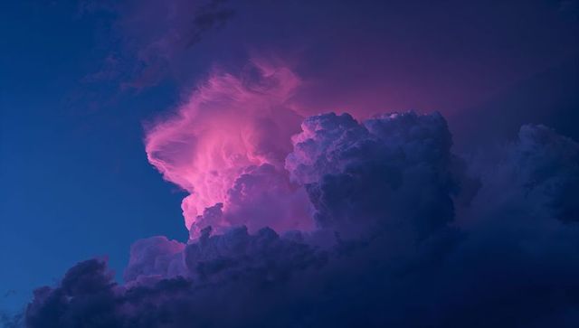 Dramatic Glowing Cumulonimbus Clouds in Pink Purple Twilight