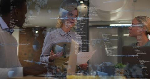 Leading team meeting holding headset and reports with digital data overlay in office