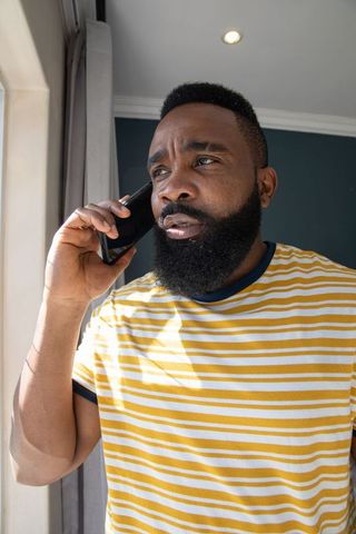Casual African American Man Talking on Smartphone by Natural Light