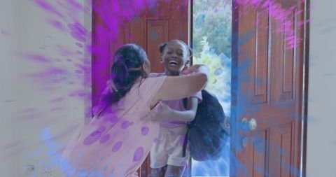 Joyful grandparent hugging granddaughter at doorway with vibrant color splashes