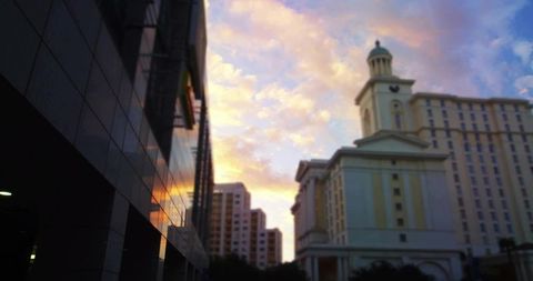 Neoclassic building with cupola at dusk in modern urban skyline