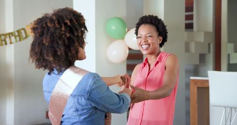 Lesbian Couple Embracing at Home Smiling Joyfully