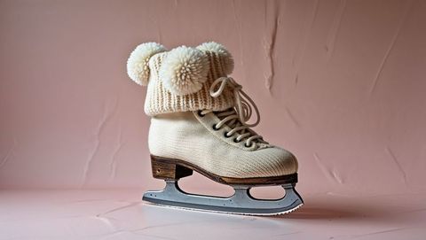 Cream knit ice skate with pom-pom hat stylish winter ice skating display